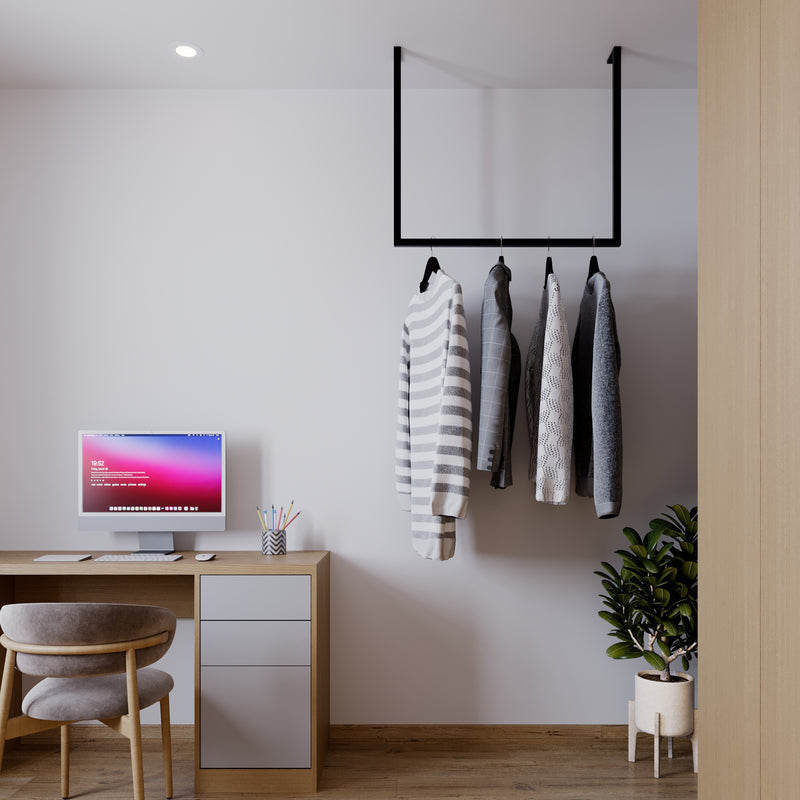 Simplistic clothes rack for jackets in the office made from square black iron pipes