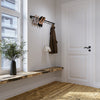 minimalistic entrance design perfect for narrow hallway made with iron rail to hang jackets on hooks