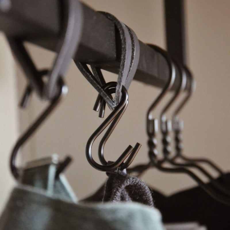 close up of clothes rail made from black iron pipes square design for hooks and hangers